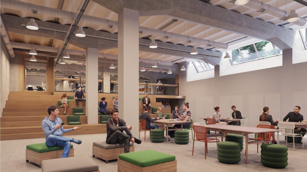 Espacio de trabajo colaborativo con diferentes zonas, mostrando la selección de oficinas que Sit&Plug ofrece a las startups.