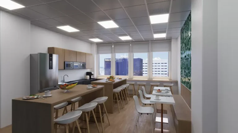 Amplia zona de office y comedor en Networkia Diagonal con mesas de madera, electrodomésticos y vistas urbanas.