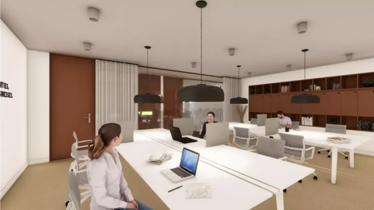 Zona de puestos de trabajo compartidos en open space con iluminación moderna y diseño funcional en Spaces La Illa.