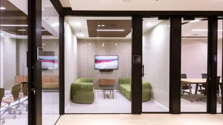 Sala de reuniones privada y acogedora con sofá verde en La Illa and co, diseñada para la máxima representatividad de direcciones generales.